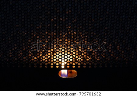 Convector. Fire behind the metal grill. Abstract photo. Background