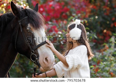 Pretty young girl with a white horse.