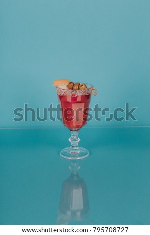 Cocktail on color background with glass reflection 