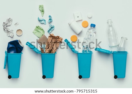 top view of trash bins and assorted garbage isolated on grey, recycle concept Royalty-Free Stock Photo #795715315