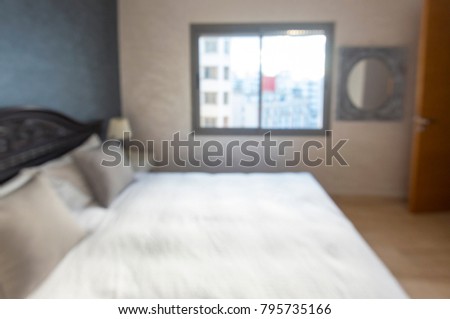 Abstract blurred picture of a bedroom as background