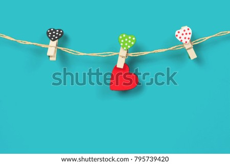 Handmade wood hearts hanging on cloth line or rope with 

background.clipping path.