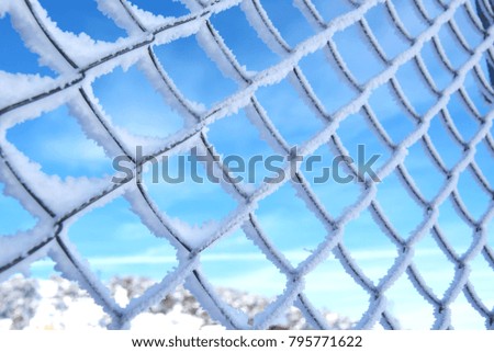 Snow on a steel fence
