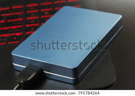 Portable hard disk drive for storage computer data files and glow laptop keyboard