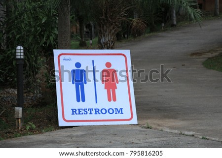the restroom sign in the park background