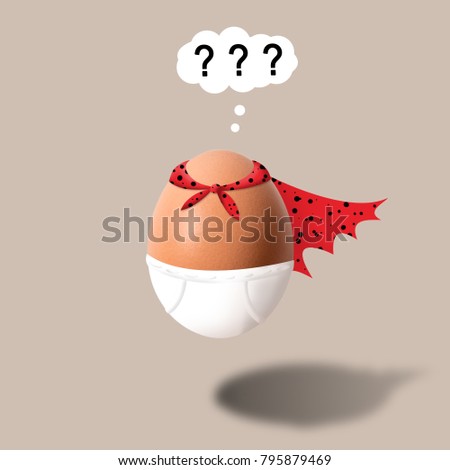 Funny egg in underpants and cape with question mark on a brown background.