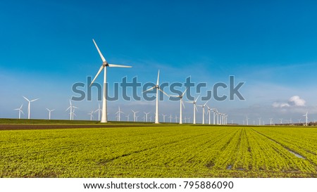 Offshore Windmill farm in the ocean  Westermeerwind park , windmills isolated at sea on a beautiful bright day Netherlands Flevoland Noordoostpolder Royalty-Free Stock Photo #795886090