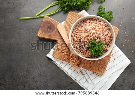 Bowl of tasty buckwheat porridge on table, top view Royalty-Free Stock Photo #795889546