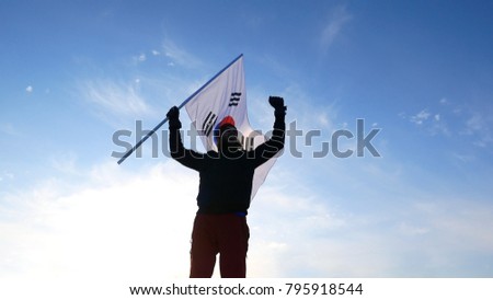 Male fan with South Korean flag rejoices and supports athletes.