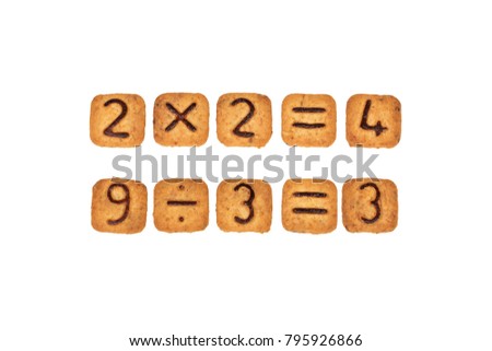 Sums made of square cookies with chocolate numerals on them. Isolated on white background. Idea of funny and easy math learning during eating. Flat lay. Top view.