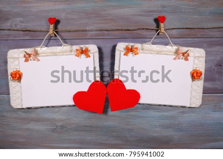 love card , valentine concept three photo paper attach to rope with clothes pins on love card , valentine concept