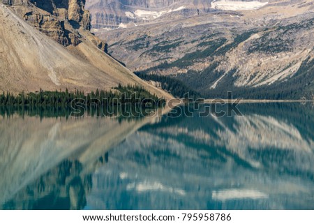 Bow lake in Canada with reflexion leading to a symmetric abstract landscape picture