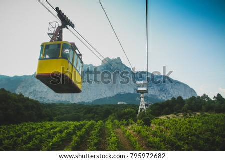 Yellow cable car or gondola under the Ay Petri mountain in southern crimea, close to Yalta in Ukraine. Royalty-Free Stock Photo #795972682