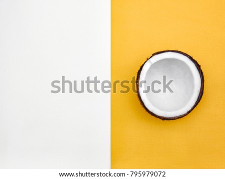 Coconut Flat lay Half coconut in peel is lying on two-tone background Top view Trendy colorful photo mockup with space for text