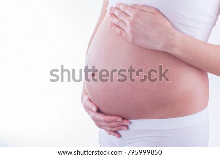 The picture of baby bump isolated on white background. The happiness of expecting a new family member.