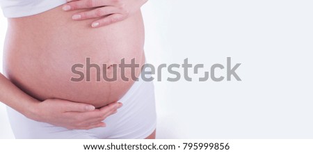 The picture of baby bump isolated on white background. The happiness of expecting a new family member.