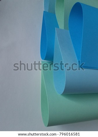 Green and blue constructed paper tear drop rolled shape