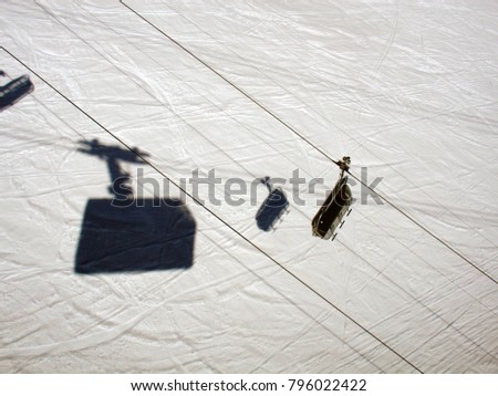A high angle view of a shadow of a ski lift cabin in the alps switzerland