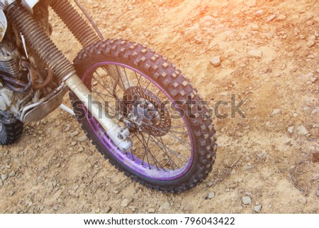 The Wheel of motocross bike on desert ground in sunny day