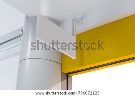 Blank white interior sign hanging from wall against yellow background from lower angle.
