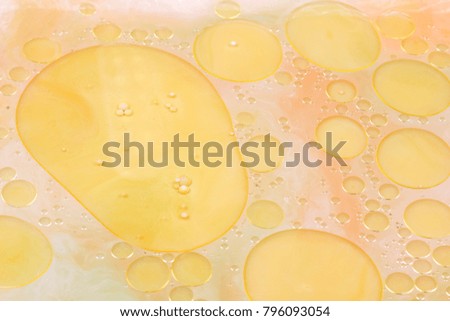 Drops of vegetable oil on liquid, abstract background, pop art texture, yellow circles on a light background, minimalism, pastel pattern