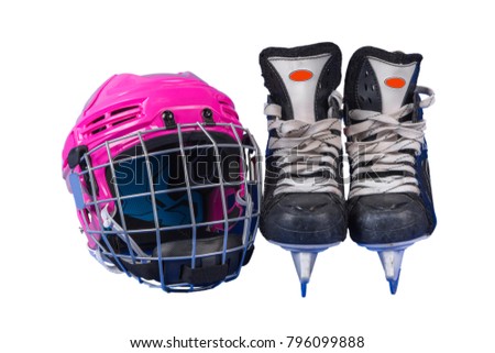 Children's hockey helmet and skates photographed against a white background