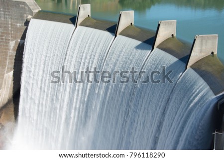 Water spills over the top of Englebright Dam on the Yuba River. Royalty-Free Stock Photo #796118290