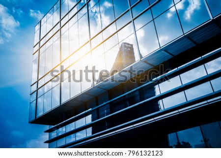 Clouds Reflected in Windows of Modern Office Building
