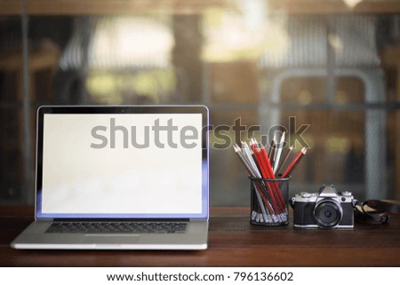 Stylish workspace with desktop computer,camera office supplies and laptop at office. desk work concept.