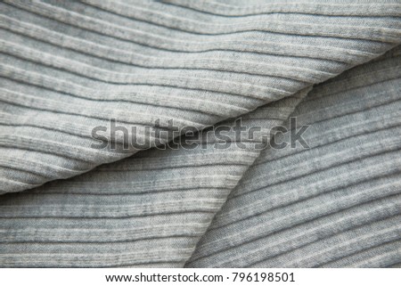 The fabric is laid out waves. Black and white canvas material textiles.
