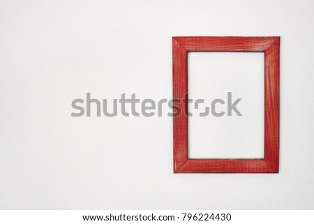 empty wooden frame on composition wall as concept, copy space
