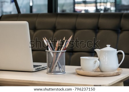 Laptop, Pencils, Notebook on wooden office table. Business concept. 