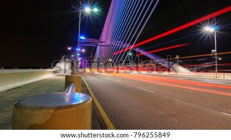 Light trails, traffic transportation light on road at Putrajaya bridge. Long exposure light trails