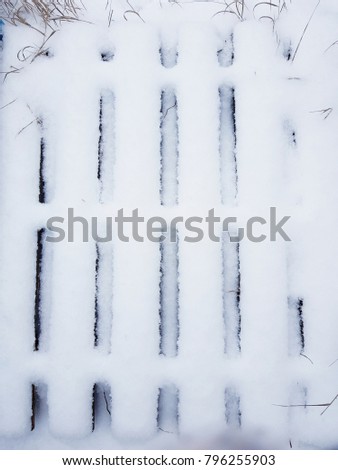 Rustic wooden fence covered with snow