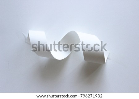 Paper swirl sculpture with light and shade and shadows on white background Royalty-Free Stock Photo #796271932