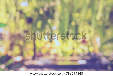 Abstract Blurred image of Outdoor Restaurant or Cafe with green bokeh for background usage. (vintage tone)