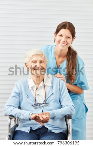 Young nursing woman or nurse and smiling senior citizen in wheelchair