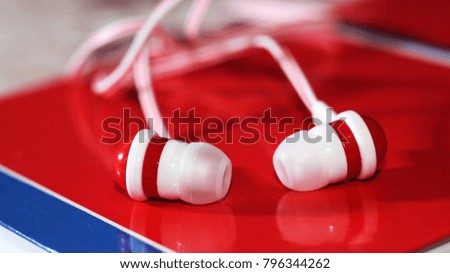 Close up on red earbuds, a trendy device for the player, sound