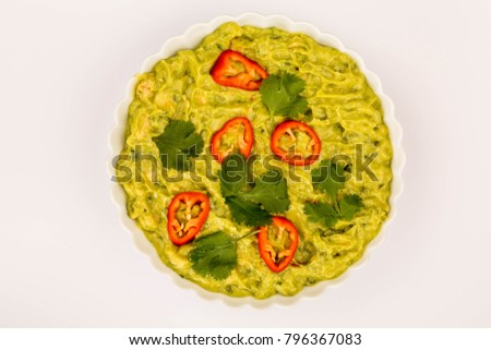 Vegetarian Mexican Style Guacomole Food Dip With Red Chillies Isolated Against A White Background
