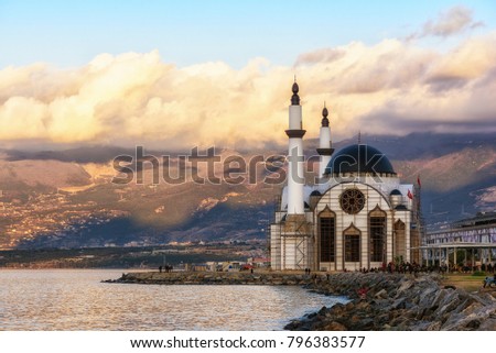 Mountain and embankment in Iskenderun port on the sunset. Winter, January. View to the mosque. Royalty-Free Stock Photo #796383577