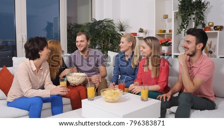 Happy Friends Bonding and Talking Sitting on Sofa Cheerful Lifestyle Activity in Home Living Room
