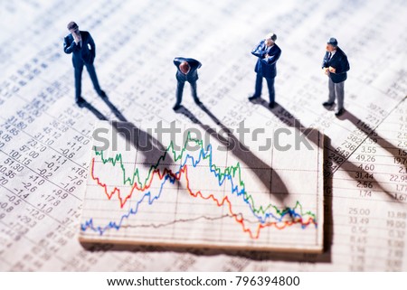 Businessmen are skeptical looking at stock market charts. Royalty-Free Stock Photo #796394800