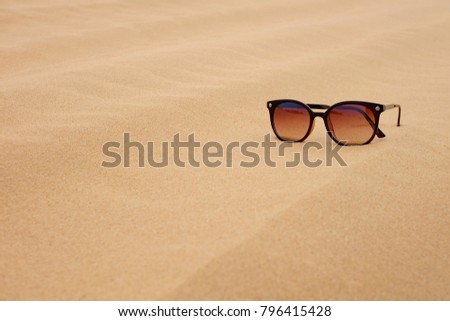 Sunglasses and white sand dunes