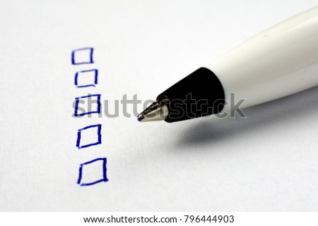 to do list on a white sheet of paper, pen notes completed check box. self management concept, close up, selective focus
