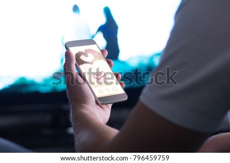 Online dating app in smartphone. Using mobile phone application to meet women. Single man trying to find relationship from internet. Royalty-Free Stock Photo #796459759