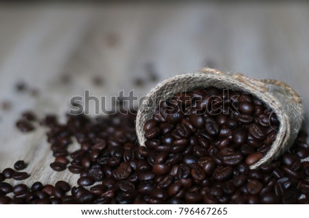 coffee beans in bag on wooden background