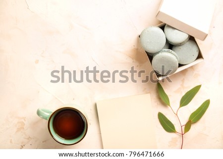 Stylish composition of French macaroons box, coffee cup, eucalyptus & cotton on white pink stucco plaster texture. Happy valentine Birthday spring present. Copy space, flat lay, top view, background.