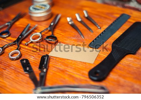 tools for hairstyles, scissors, razors, and an empty business card. place for text typing. the usual set of devices in the barbershop