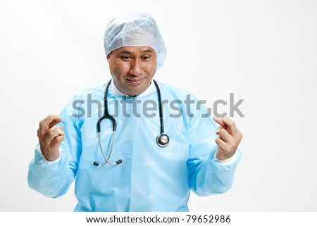 Closeup Portrait of male doctor-crossed fingers over white background