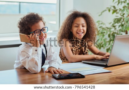 Cute boy and a girl working together as a team  Royalty-Free Stock Photo #796541428